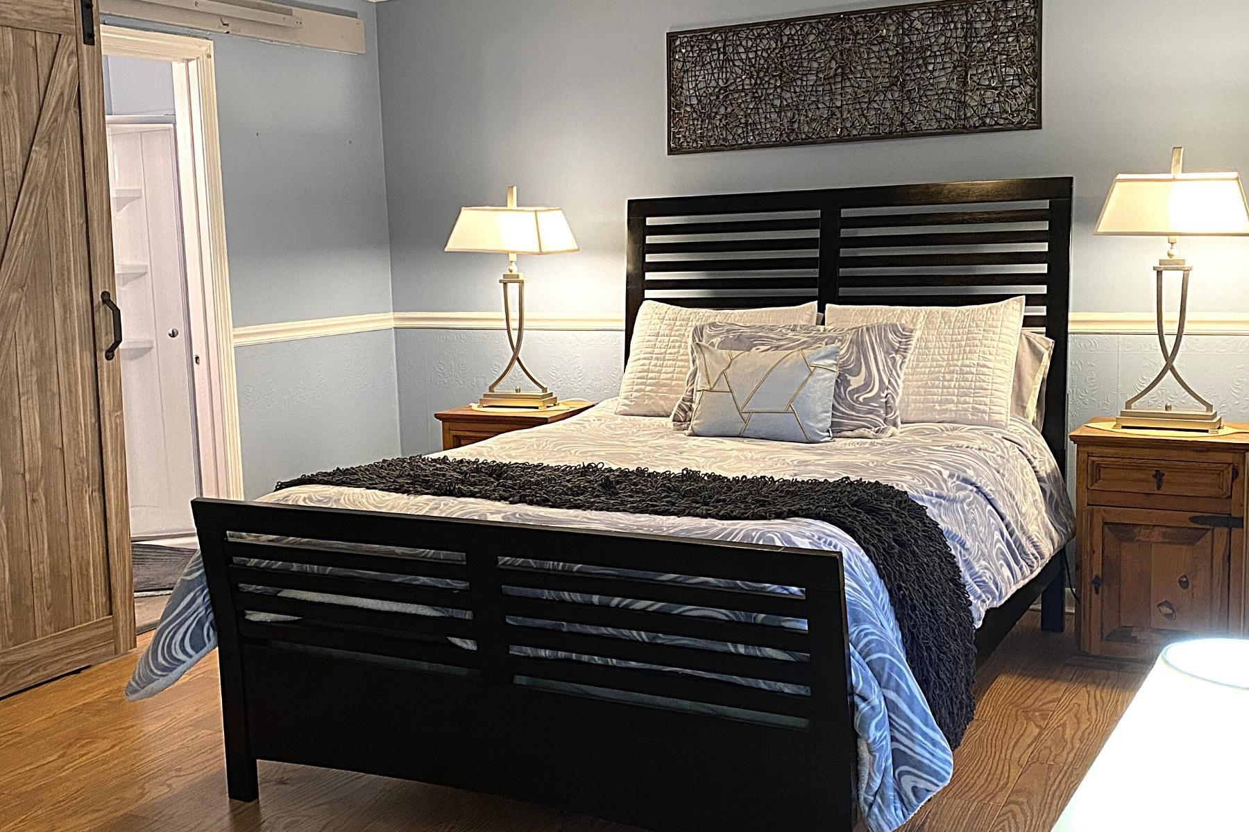 300 Buck Island Road, Unit 7B West Yarmouth, MA 02673 - Photo 13 of 22 a bedroom with a bed and a lamp on dresser