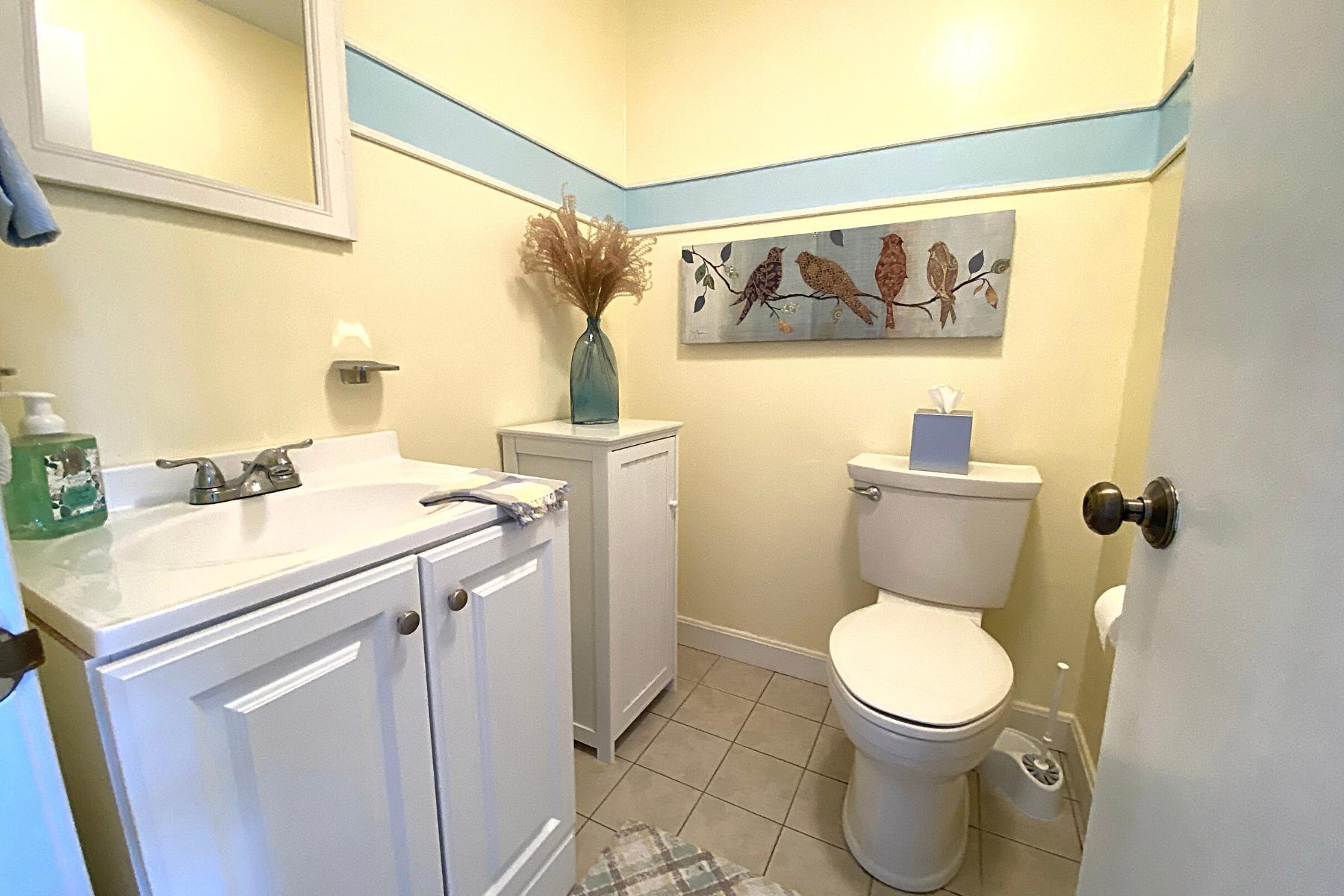 300 Buck Island Road, Unit 7B West Yarmouth, MA 02673 - Photo 19 of 22 a bathroom with a toilet sink and mirror