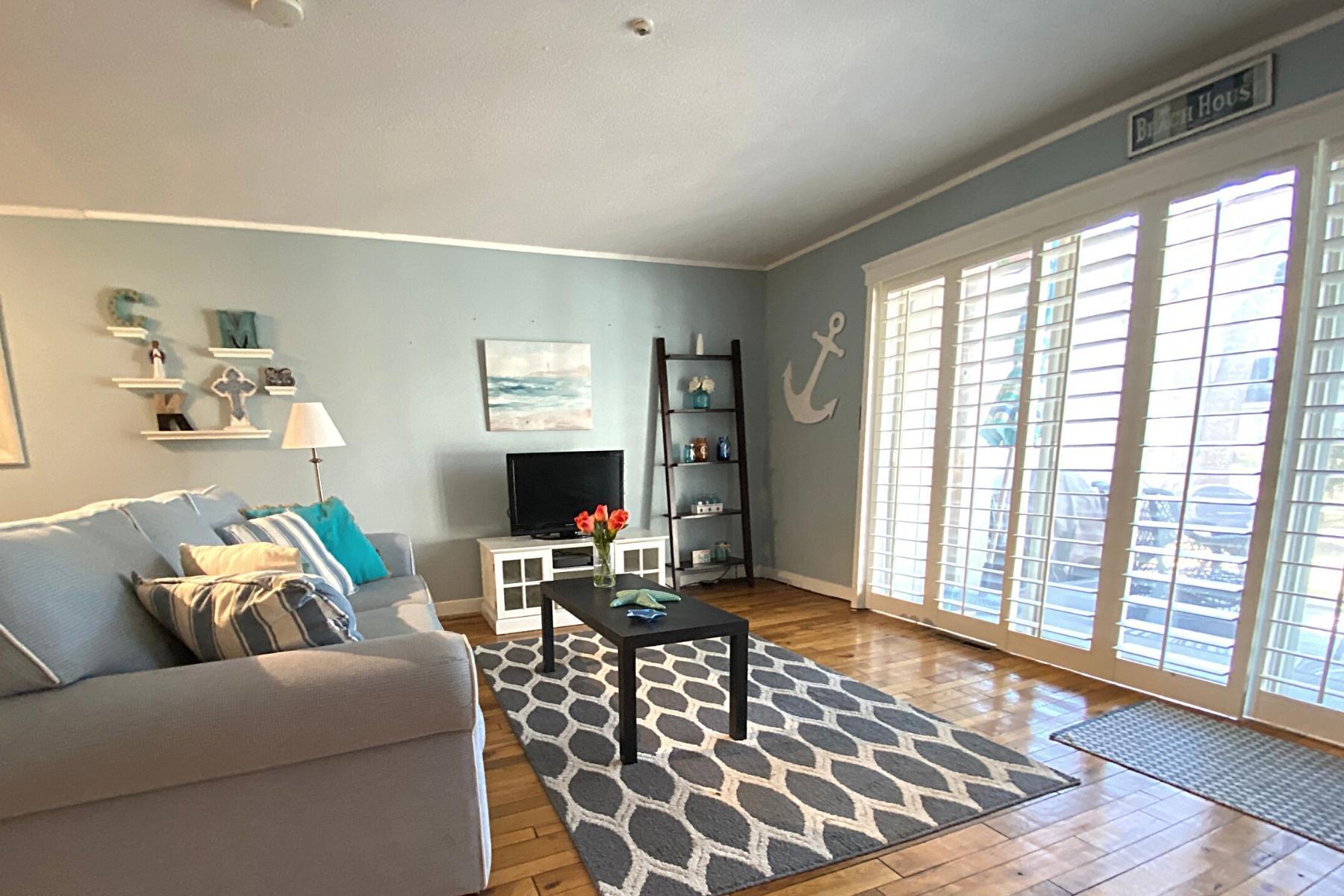 300 Buck Island Road, Unit 7B West Yarmouth, MA 02673 - Photo 4 of 22 a living room with furniture and a flat screen tv