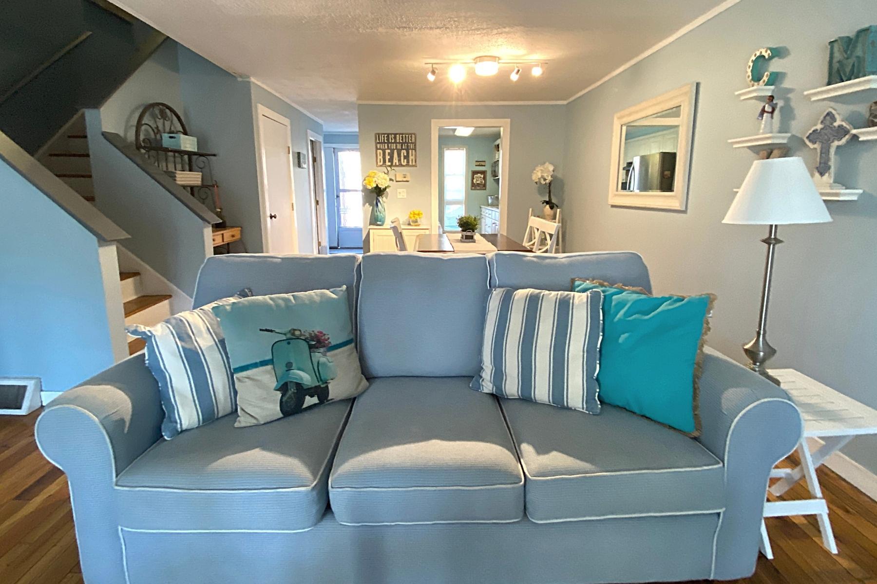 300 Buck Island Road, Unit 7B West Yarmouth, MA 02673 - Photo 5 of 22 a living room with furniture and a lamp