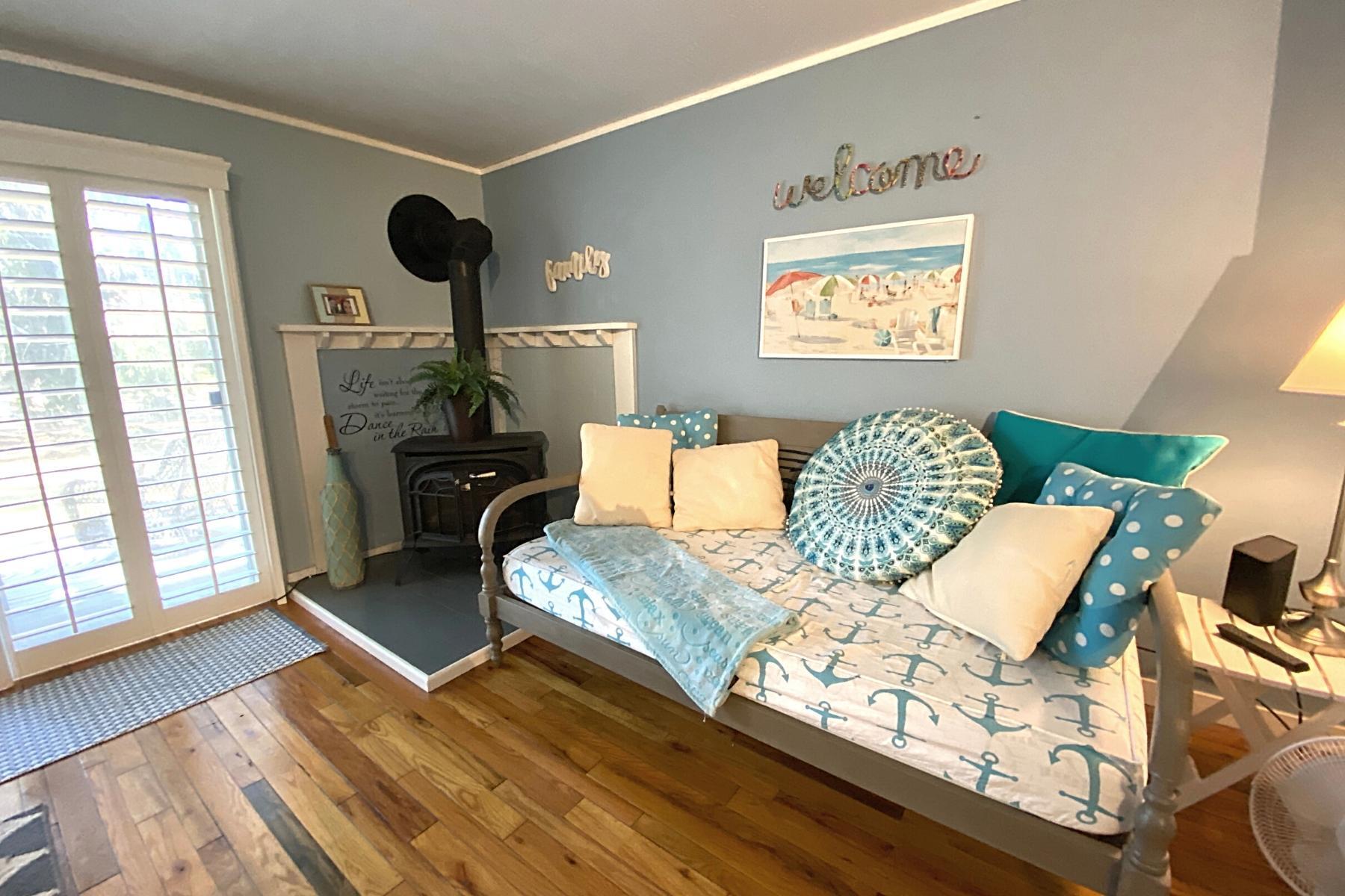 300 Buck Island Road, Unit 7B West Yarmouth, MA 02673 - Photo 7 of 22 a living room with furniture and a large window