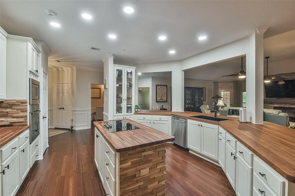 a large kitchen with kitchen island a large counter top space a sink and stainless steel appliances