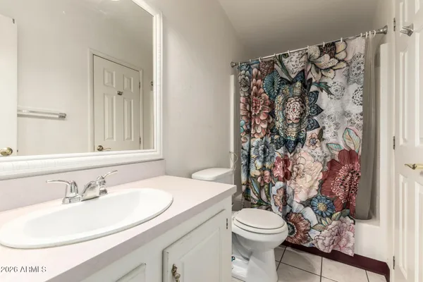 a bathroom with a sink toilet and mirror