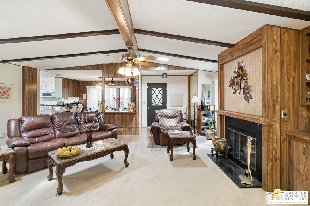18555 Roberts Road, Unit 103 Desert Hot Springs, CA 92241 - Photo 1 of 30 a living room with furniture and a fireplace