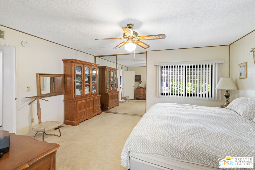 18555 Roberts Road, Unit 103 Desert Hot Springs, CA 92241 - Photo 12 of 30 a bedroom with a bed next to a window with the outer view
