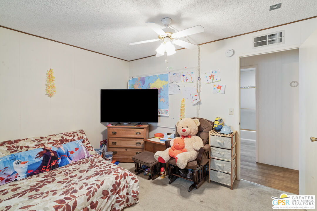 18555 Roberts Road, Unit 103 Desert Hot Springs, CA 92241 - Photo 17 of 30 a bedroom with bed and a flat screen tv