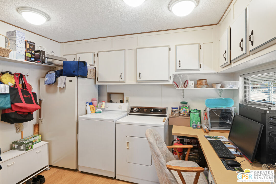 18555 Roberts Road, Unit 103 Desert Hot Springs, CA 92241 - Photo 19 of 30 a view of kitchen with stainless steel appliances cabinets and a refrigerator