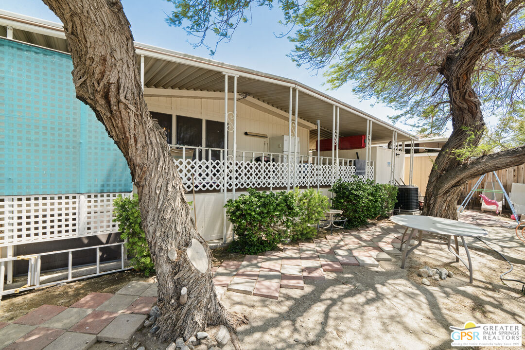 18555 Roberts Road, Unit 103 Desert Hot Springs, CA 92241 - Photo 24 of 30 a front view of a house with a garden