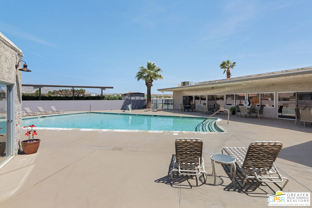 18555 Roberts Road, Unit 103 Desert Hot Springs, CA 92241 - Photo 28 of 30 a view of a chairs and table on the terrace