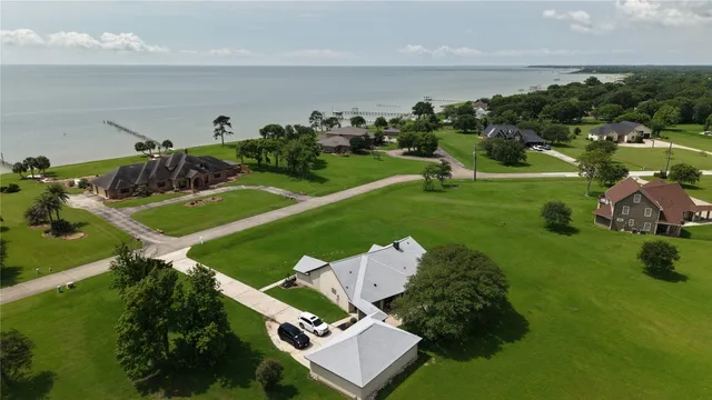 an aerial view of a house with a yard basket ball court and outdoor seating