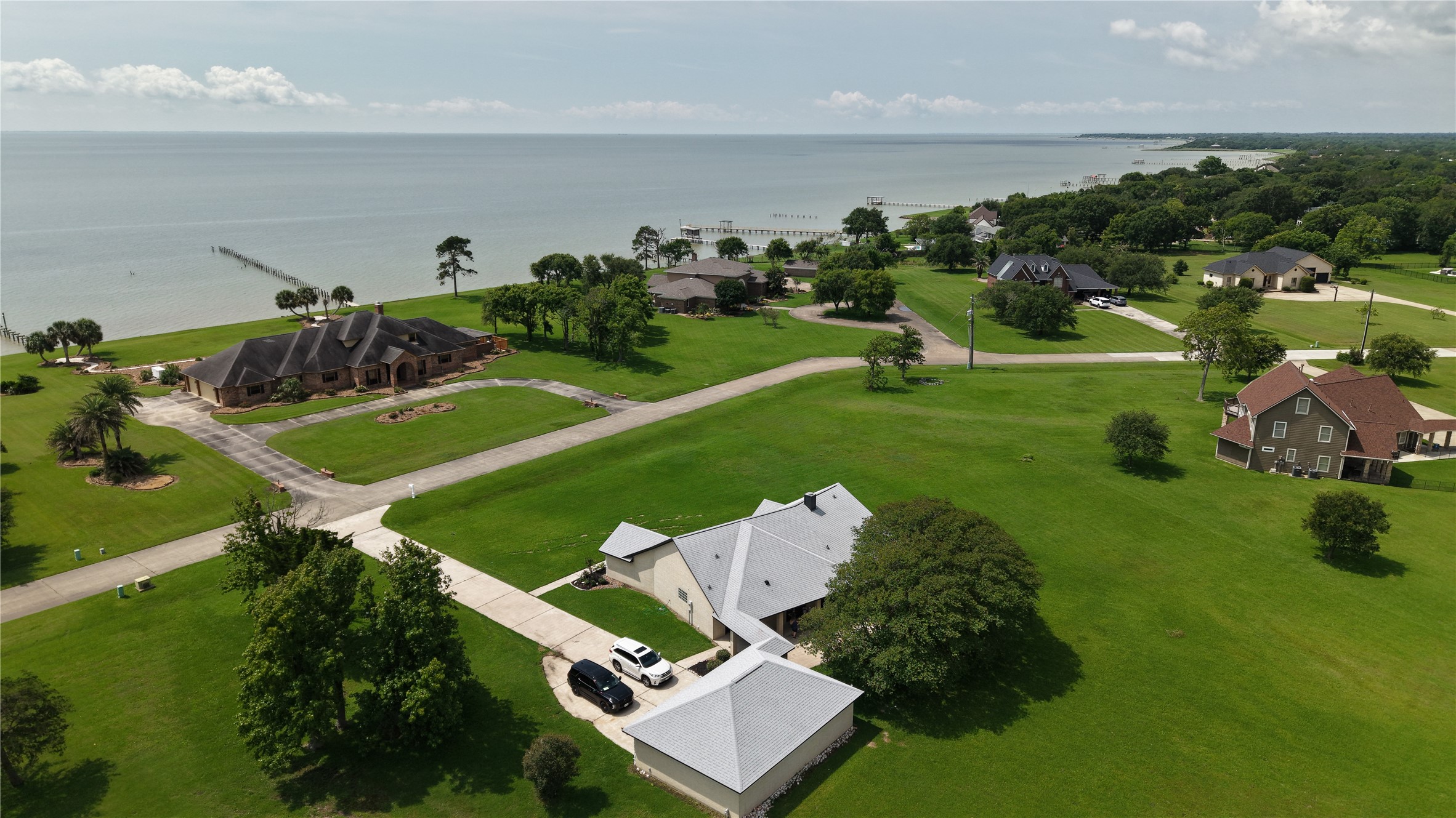 an aerial view of a house with a yard basket ball court and outdoor seating