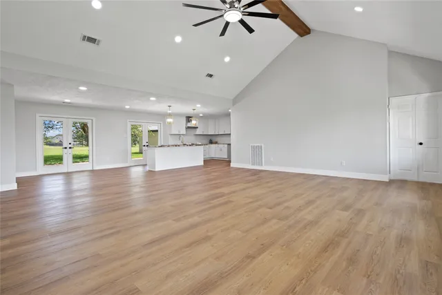 a kitchen with kitchen island granite countertop stainless steel appliances cabinets a sink and a counter top space