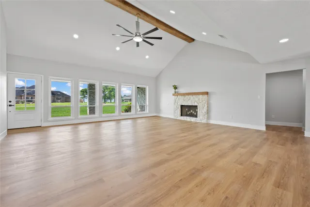 a large kitchen with stainless steel appliances granite countertop a stove oven a sink dishwasher and a dining table with wooden floor