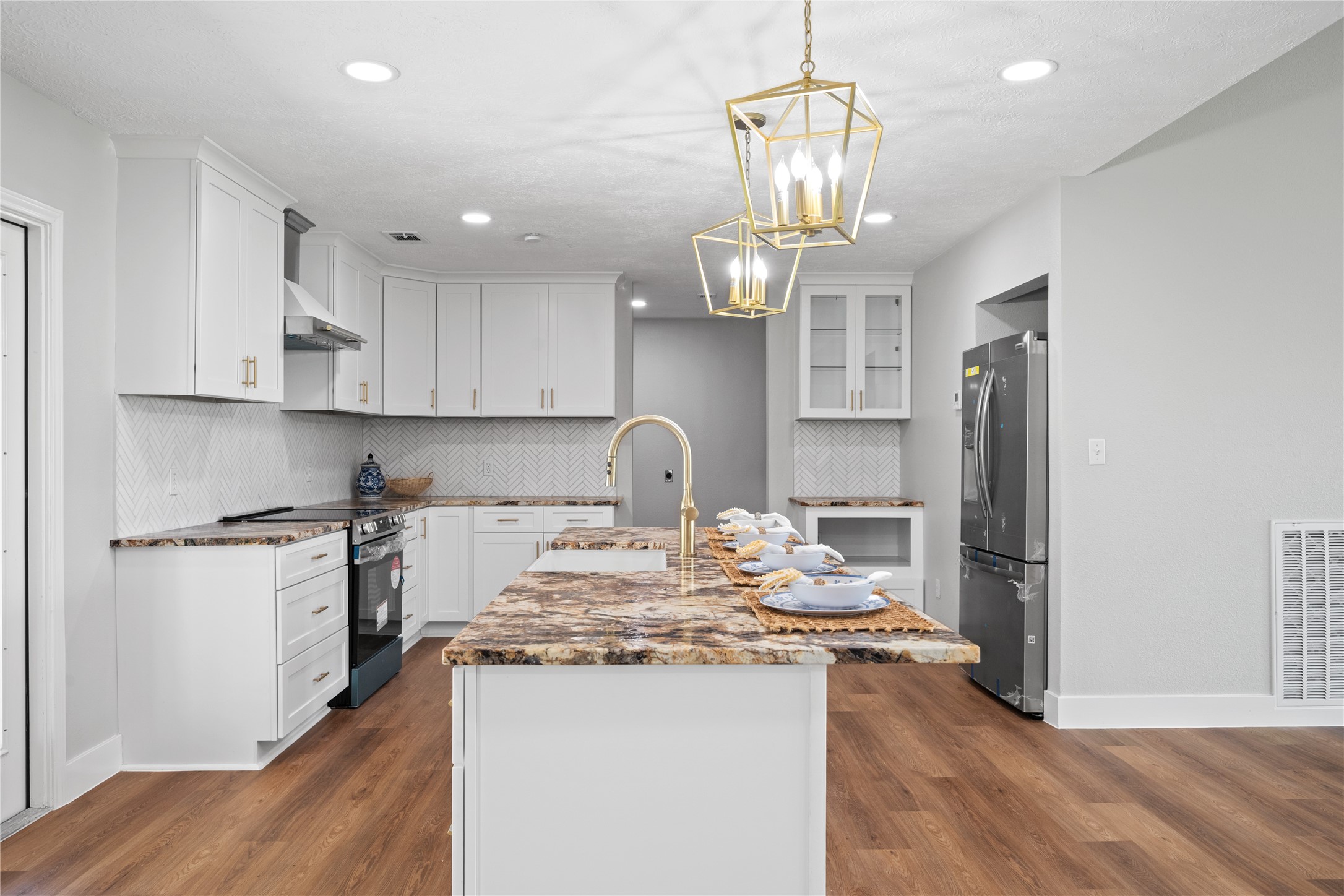 9035 Water Point Drive Beach City, TX 77523 - Photo 15 of 36 a kitchen with kitchen island granite countertop stainless steel appliances cabinets a sink and a counter top space