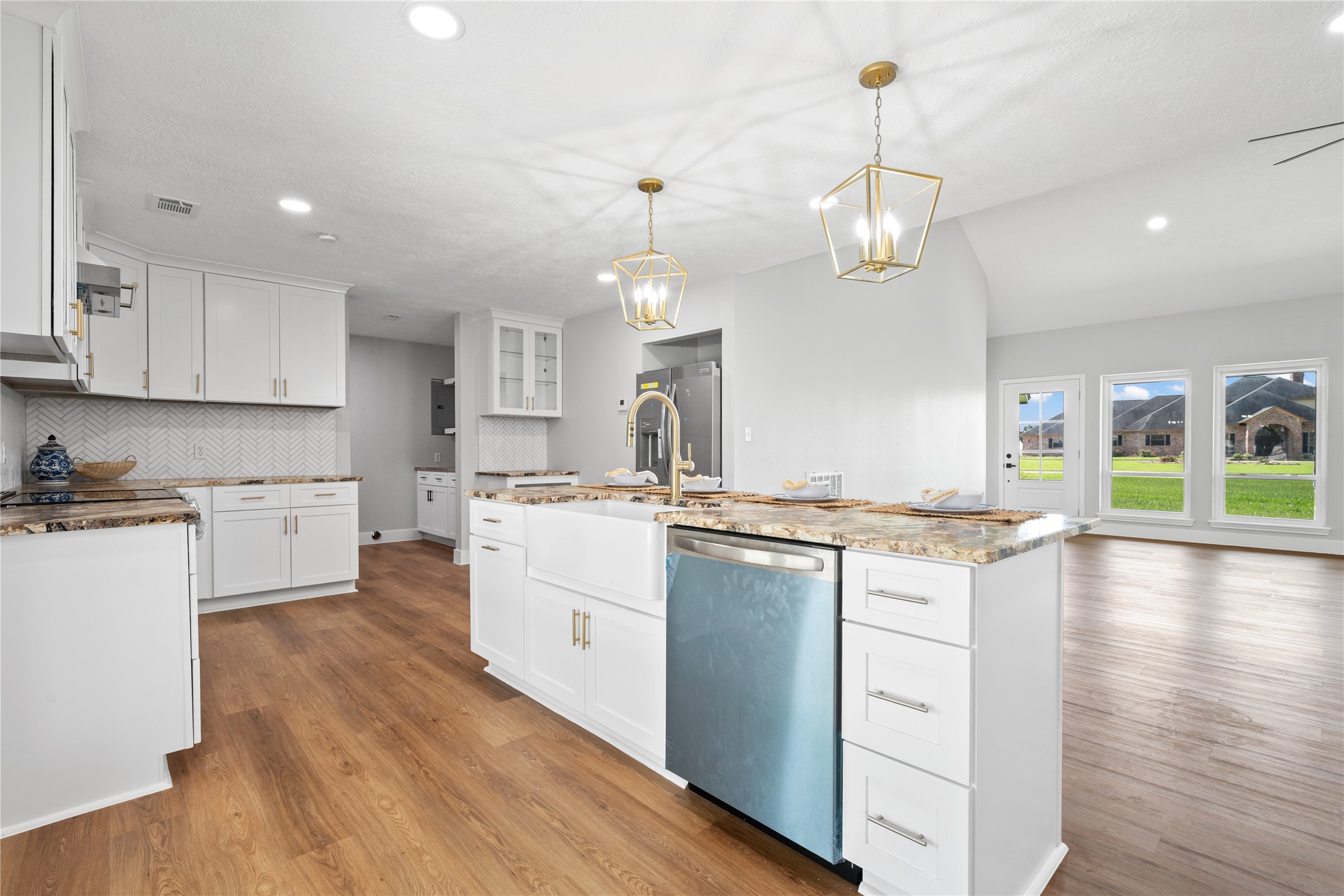 9035 Water Point Drive Beach City, TX 77523 - Photo 17 of 36 a large kitchen with granite countertop a stove a sink a center island and wooden floor