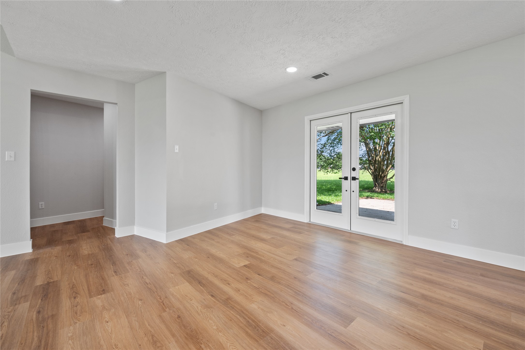 9035 Water Point Drive Beach City, TX 77523 - Photo 19 of 36 a view of an empty room with wooden floor and a window