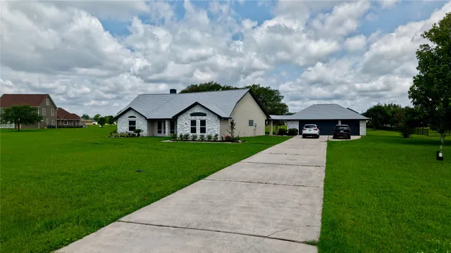 a front view of house with yard and green space