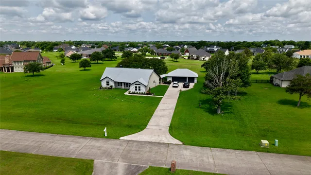 an aerial view of a house with garden space and street view