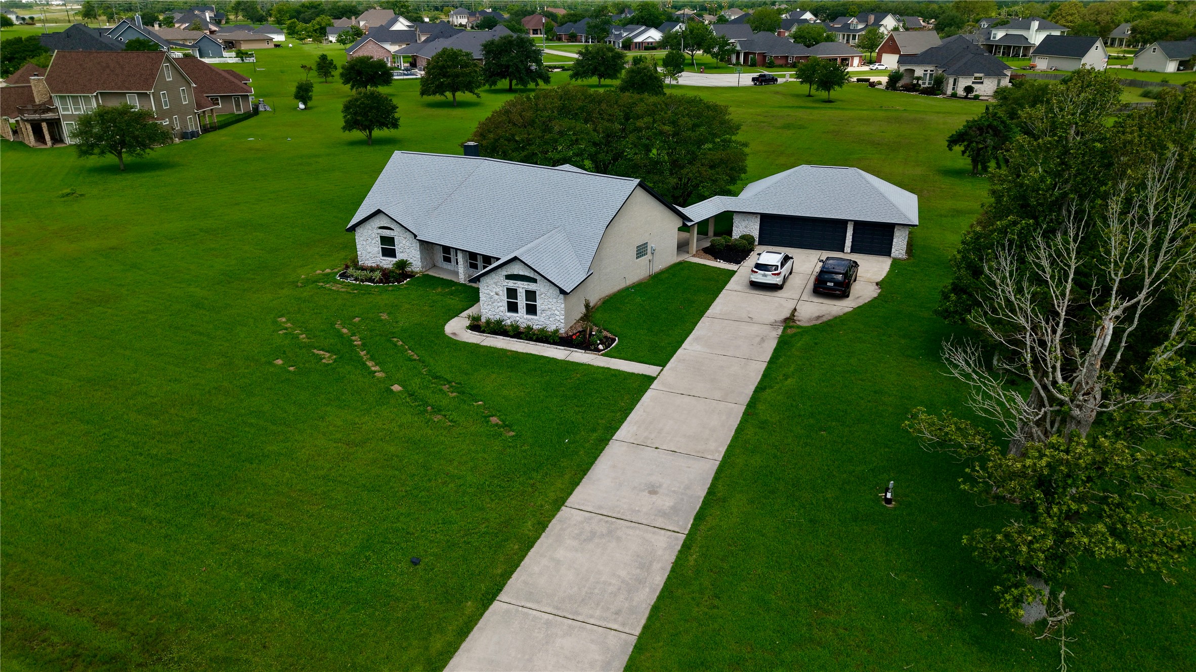 9035 Water Point Drive Beach City, TX 77523 - Photo 8 of 36 a view of a table and chairs under an umbrella in big yard with large trees