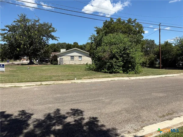 a front view of a house with a garden and yard