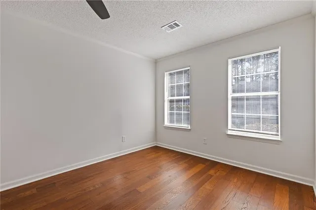 a view of empty room with wooden floor and fireplace