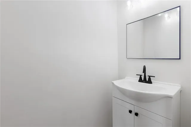 a view of a kitchen with wooden floor and a sink