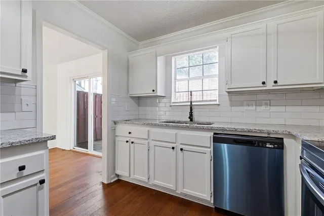 a kitchen with stainless steel appliances granite countertop a refrigerator sink and stove