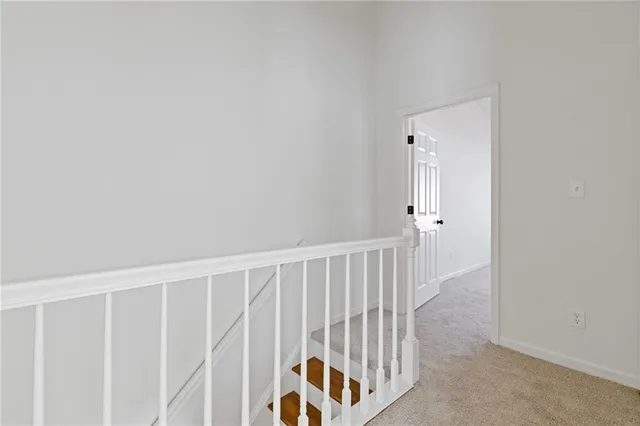a bedroom with a large bed a flat screen tv and a window