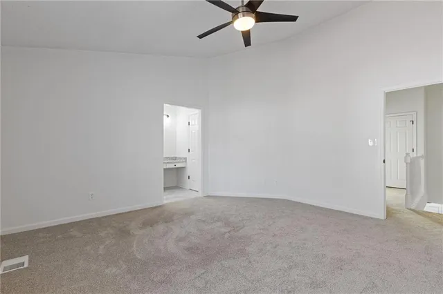a bathroom with a granite countertop sink a toilet and bathtub
