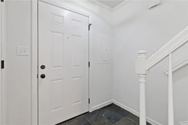 a living room with furniture a fireplace and a potted plant