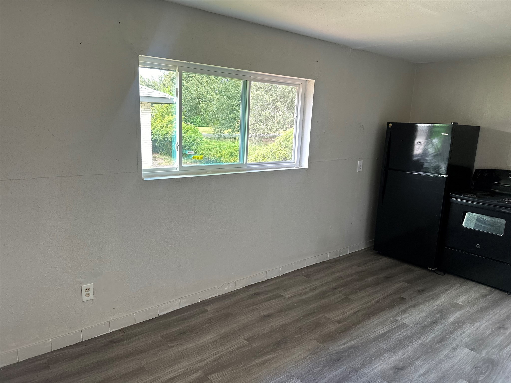 5409 Suez Street, Unit 4 Houston, TX 77020 - Photo 14 of 19 a view of an empty room with wooden floor and a window