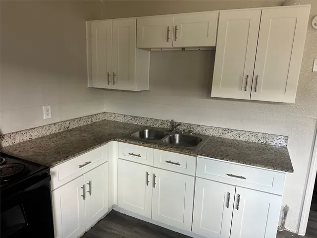 a kitchen with white cabinets and white appliances