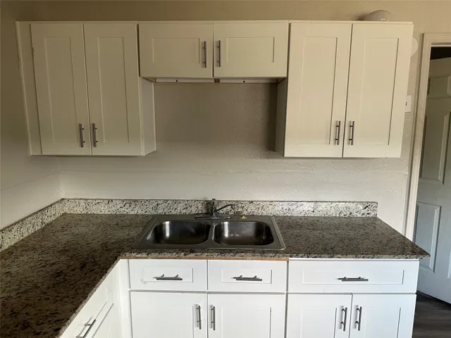 a white stove top oven sitting inside of a kitchen