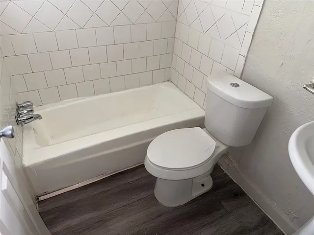 a bathroom with a toilet and a bathtub