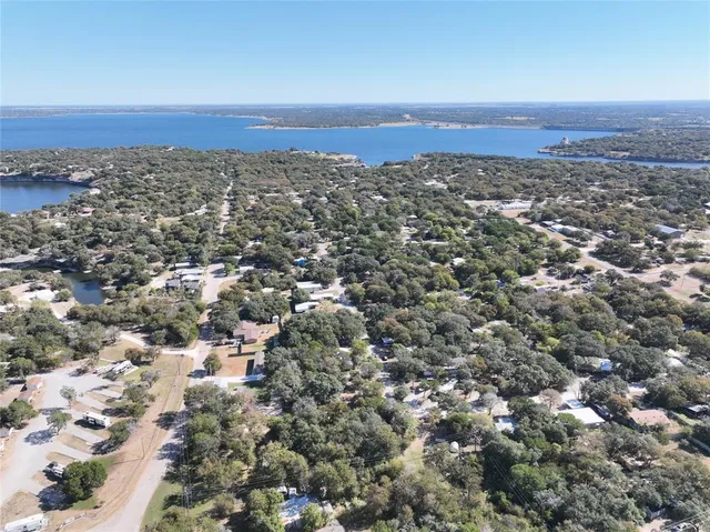an aerial view of residential houses with city view
