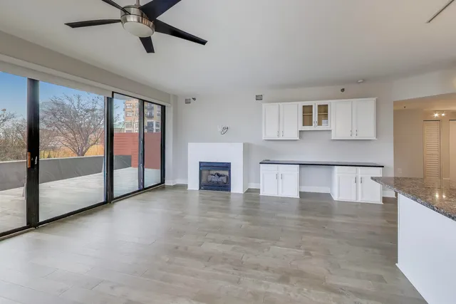 a view of a kitchen with a sink and a fireplace