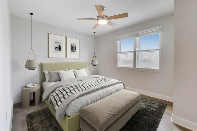 a bedroom with a large bed and a chandelier