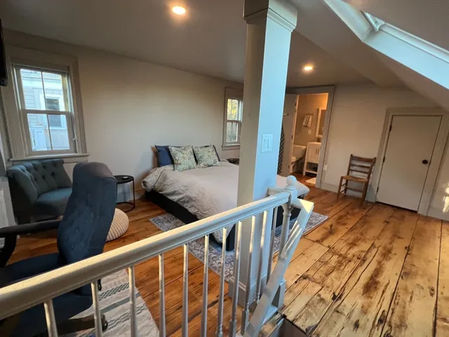 a view of a hallway with furniture