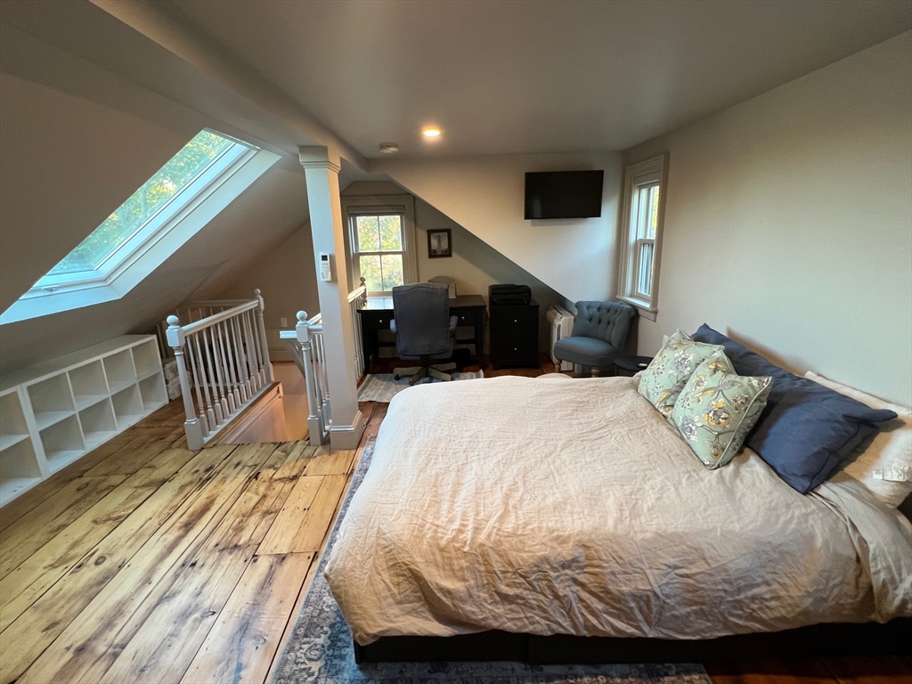 32 Buffum Street, Unit 1 Salem, MA 01970 - Photo 14 of 19 a bedroom with a bed and a large window