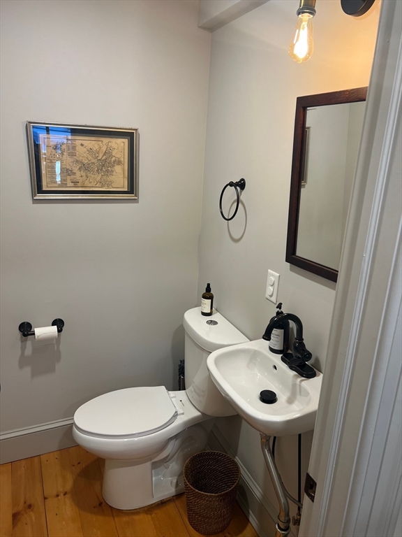 32 Buffum Street, Unit 1 Salem, MA 01970 - Photo 7 of 19 a bathroom with a toilet a sink and mirror