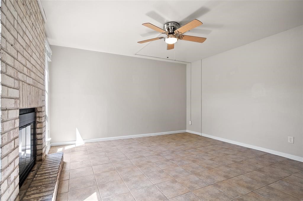 328 South 2nd Street, Unit 330 Alvin, TX 77511 - Photo 13 of 15 an empty room with chandelier fan and windows