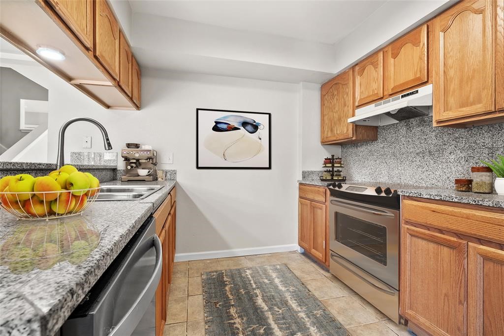 328 South 2nd Street, Unit 330 Alvin, TX 77511 - Photo 2 of 15 a kitchen with stainless steel appliances granite countertop a stove and a sink