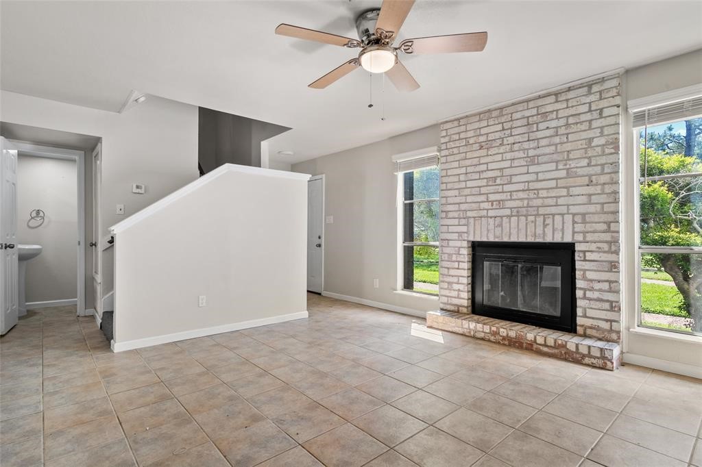 328 South 2nd Street, Unit 330 Alvin, TX 77511 - Photo 3 of 15 a view of a livingroom with a fireplace and a chandelier fan