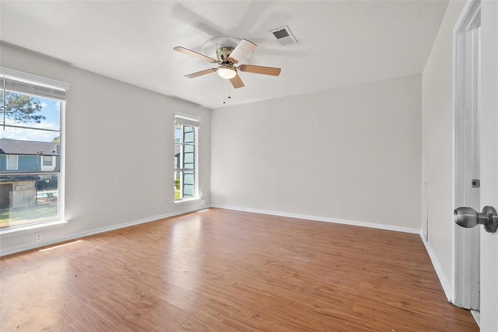 328 South 2nd Street, Unit 330 Alvin, TX 77511 - Photo 4 of 15 a view of an empty room with wooden floor and a window