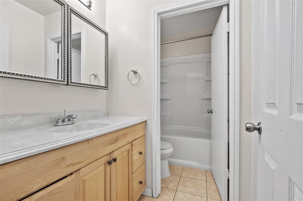 328 South 2nd Street, Unit 330 Alvin, TX 77511 - Photo 5 of 15 a bathroom with a granite countertop sink toilet and shower