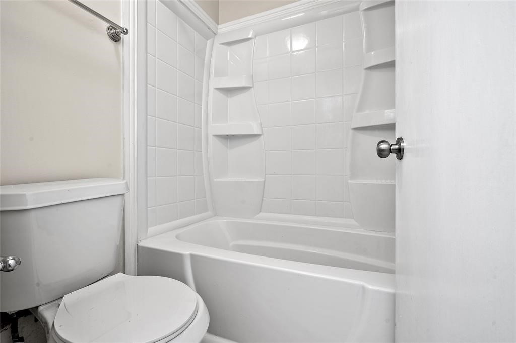 328 South 2nd Street, Unit 330 Alvin, TX 77511 - Photo 6 of 15 a white toilet sitting next to a bath tub