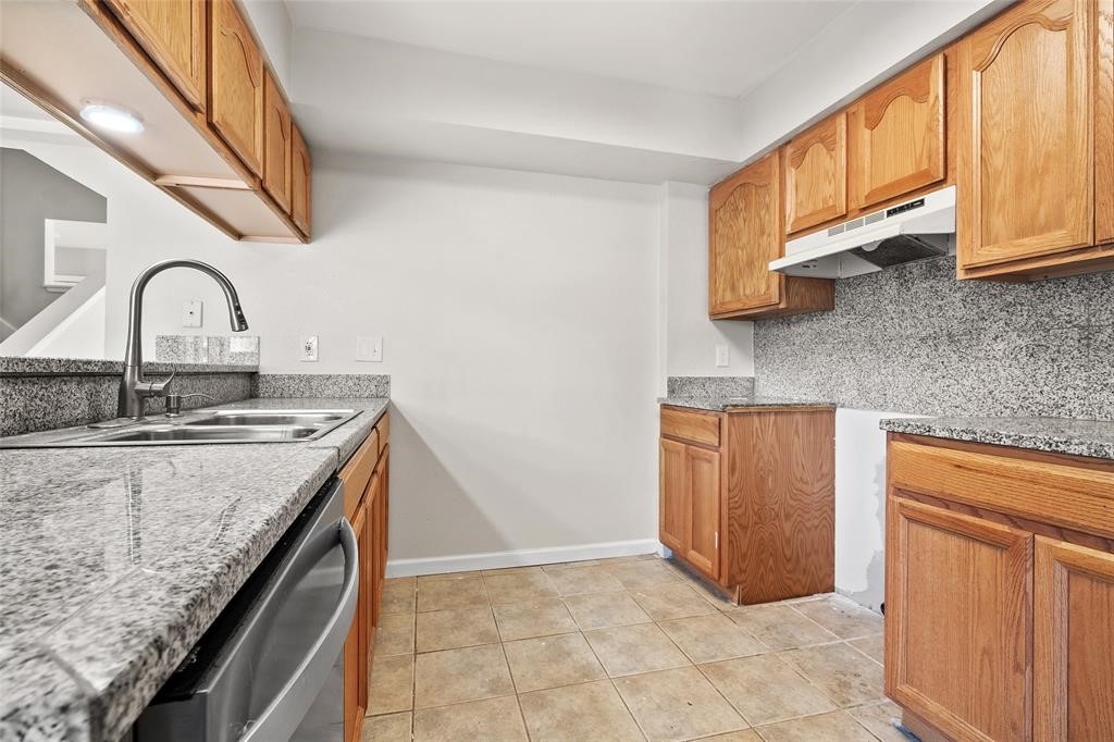 328 South 2nd Street, Unit 330 Alvin, TX 77511 - Photo 8 of 15 a kitchen with granite countertop a sink a stove and cabinets