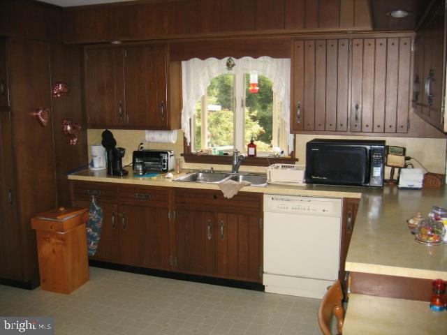 121 Royer Road Ephrata, PA 17522 - Photo 10 of 15 a kitchen with a sink and wooden cabinets