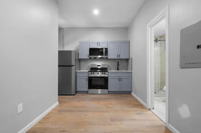 a kitchen with a refrigerator and a stove