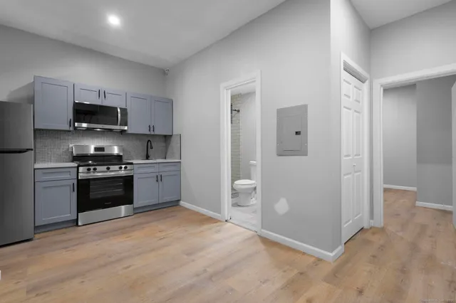 a kitchen with stainless steel appliances a refrigerator stove and microwave